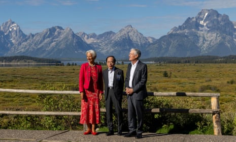 President of the European Central Bank Christine Lagarde, Bank of Japan governor Kazuo Ueda, and chair of the Federal Reserve Jerome Powell (left to right) speak in front of the Teton mountains during the Jackson Hole economic symposiumon 25 August.