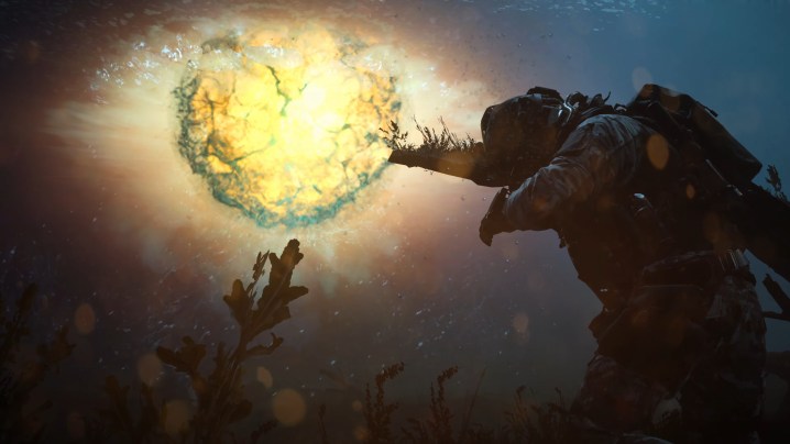 A soldier shields themself from an underwater explosion.