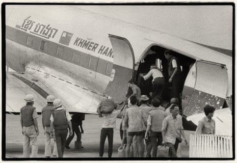 black and white picture from 1975 of Cambodians getting on plane to escape country
