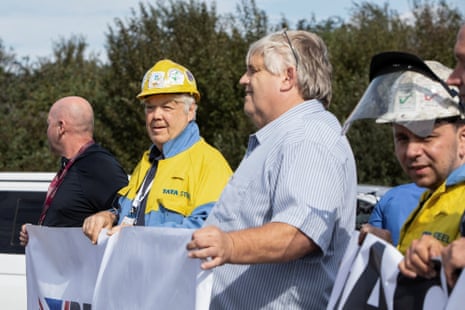 Tony Davies, 65, holds a sign with other protesters outside Tata Steel