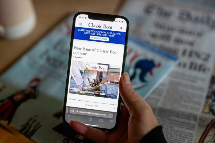 Smartphone showing Classic Boat magazine with Telegraph paper in the background