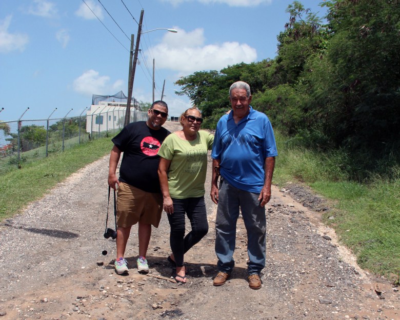 From left, José Cora Collazo, Sol Piñeiro, and Carlos Lago on the coal ash road running along Piñeiro’s home.