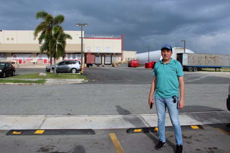 Salinas resident and environmental activist Victor Alvarado Guzmán stands across the street from a shopping center that was built on a foundation of coal ash.