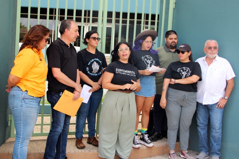 Vanessa Uriarte, executive director of the group Amigos del Mar, speaks surrounded by other activists at a press conference outside of Puerto Rico’s natural resources department in San Juan.