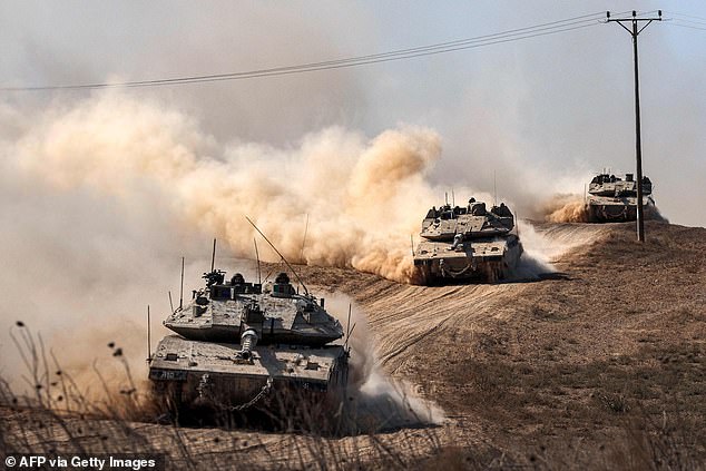 A column of Merkava main battle tanks deployed along the border with Gaza on October 13