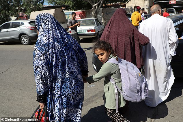 Palestinians grabbed bags and desperately tried to save the lives of their loved ones, leaving their homes behind as Israeli main battle tanks crossed into Gaza, on October 13, 2023