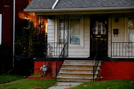 close view of white and red house facade with a sign reading justice for beniteau street residents in the window