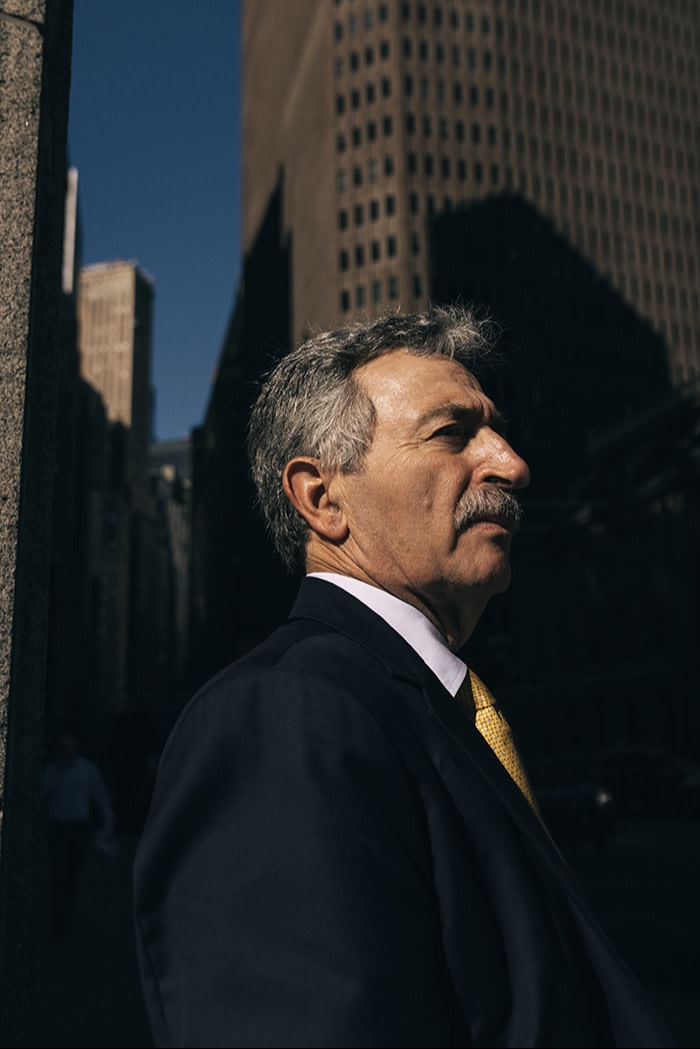 Side profile of Jon Mechanic with the city in the background