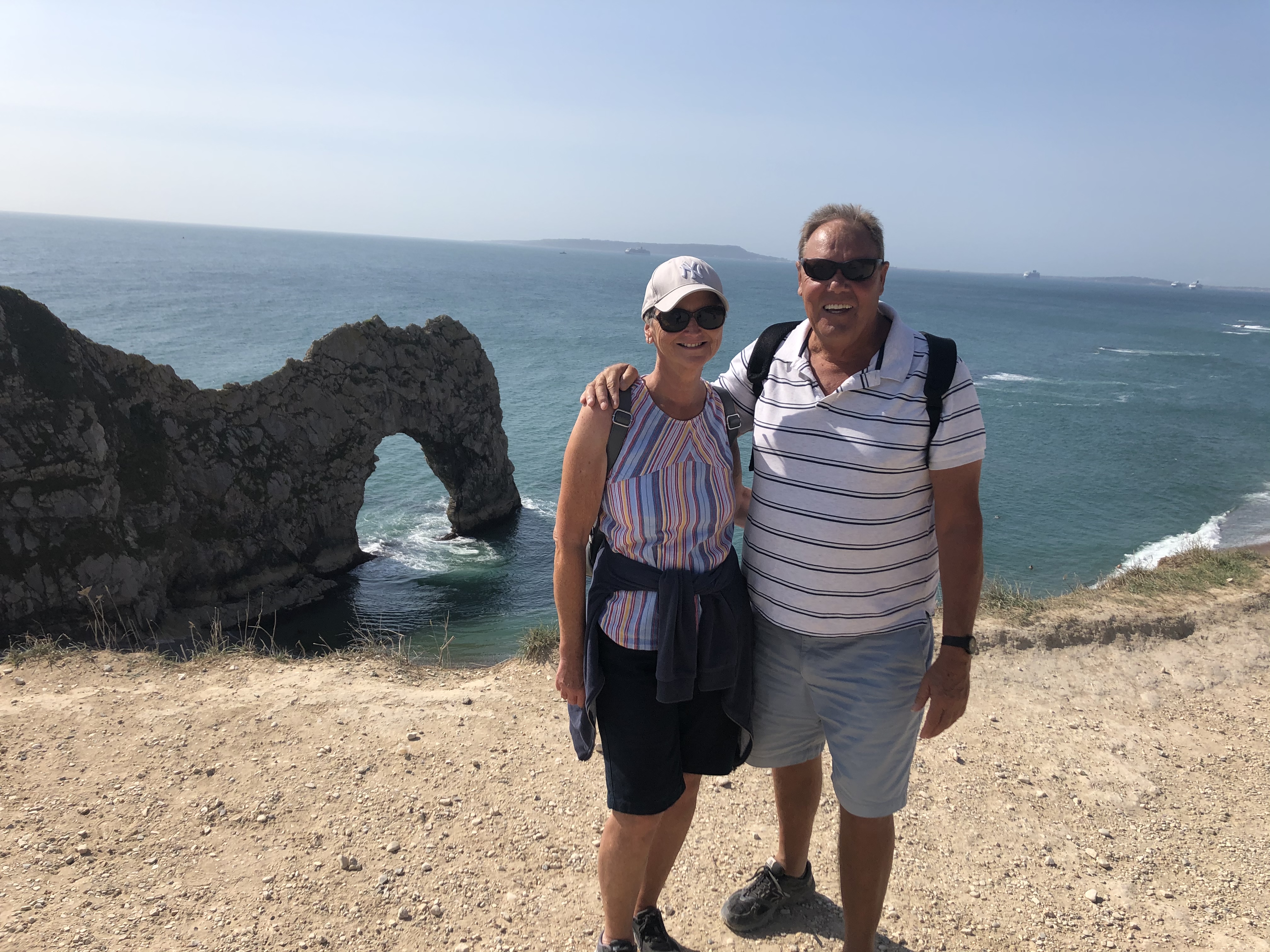 Kay and Roy Warburton smile for the camera at Durdle Door, Dorset.