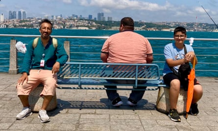 Guides and one fat man on a bench by Bosphorus