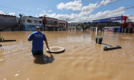 Adilson Ferreira da Silva, 38, driver, wades through the water to buy medicine for his newborn son, in the flooded Canoas neighbourhood in Rio do Sul, Santa Catarina State, Brazil, on October 10.