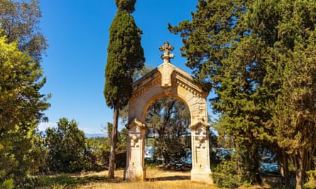 Stone arch shrine with sun and blue sea