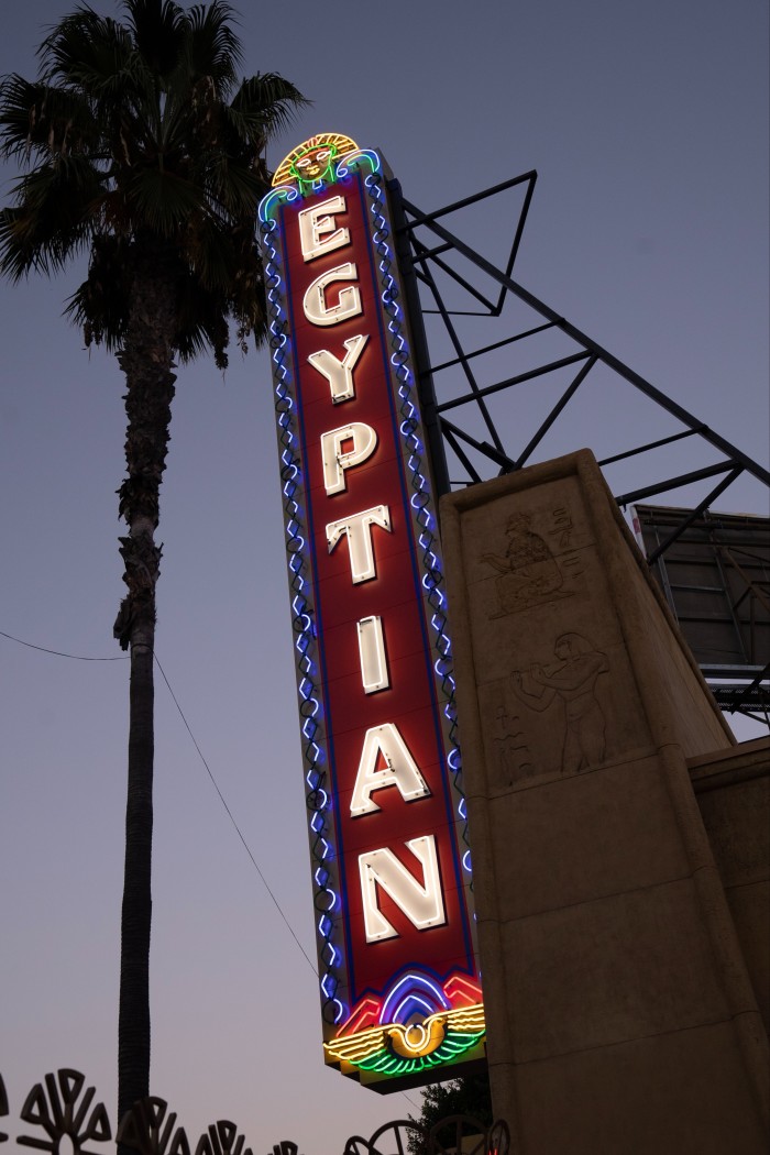 A vertical neon sign says ‘Egyptian’
