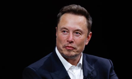 Head and shoulders shot of Musk looking at someone or something off camera