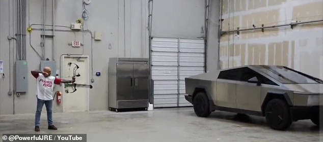 Rogan pulled back on the bow and let the arrow fly, causing a loud bang when the projectile slammed against the Cybertruck.
