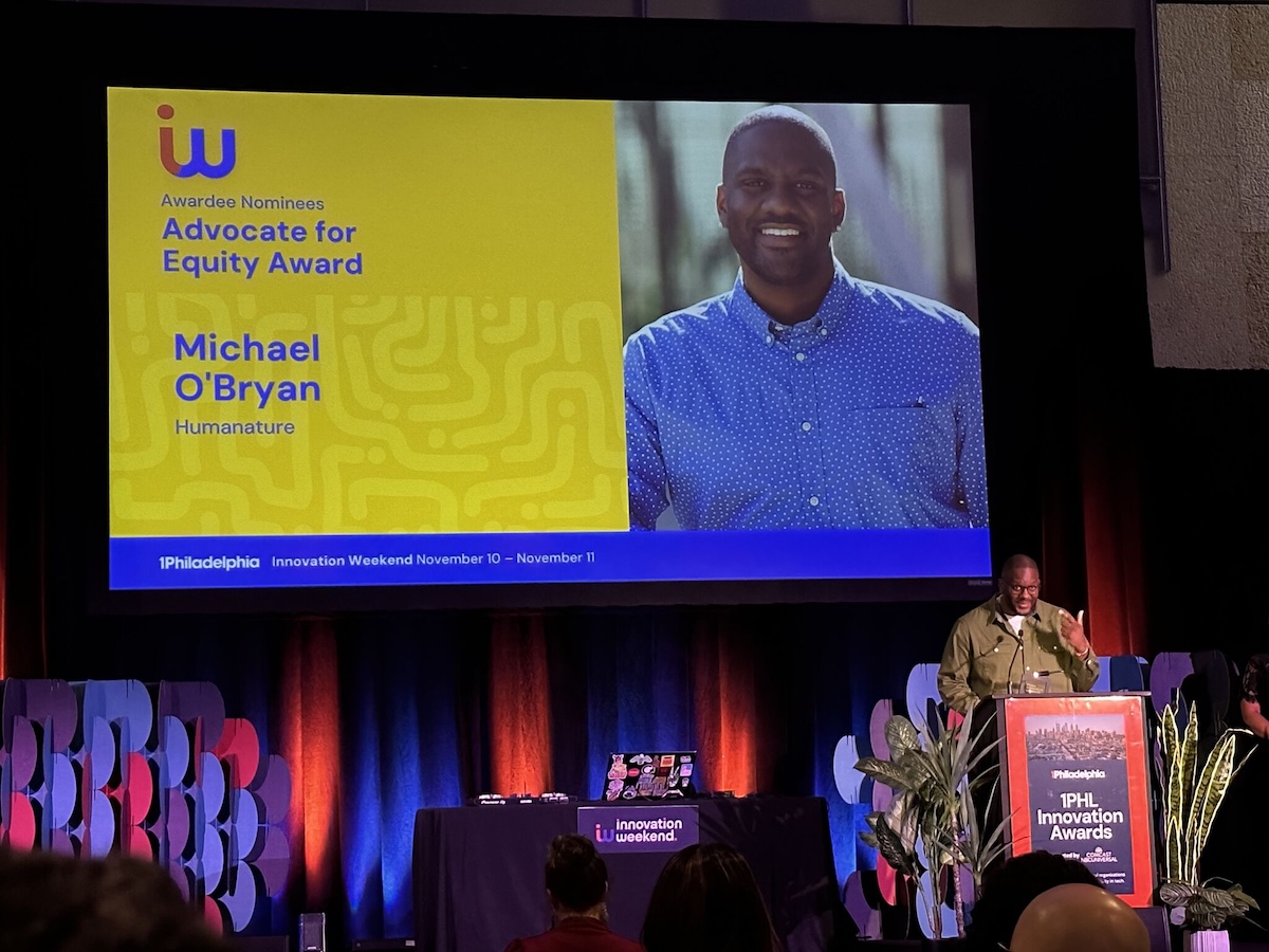 A man accepts an award onstage.