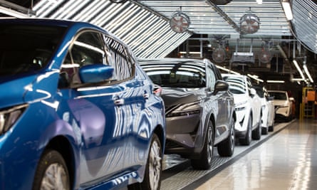 Finished Nissan cars lined up in a factory