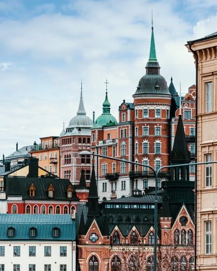 Multicoloured buildings in Stockholm’s old town with a blue cloudy sky.