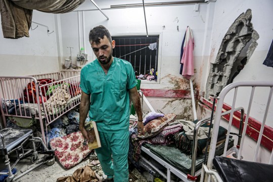 A man inspects the damage in a room following Israeli bombardment at Nasser hospital in Khan Yunis in the southern Gaza Strip on December 17, 2023, amid ongoing battles between Israel and the Palestinian militant group Hamas. (Photo by STRINGER / AFP) (Photo by STRINGER/AFP via Getty Images)