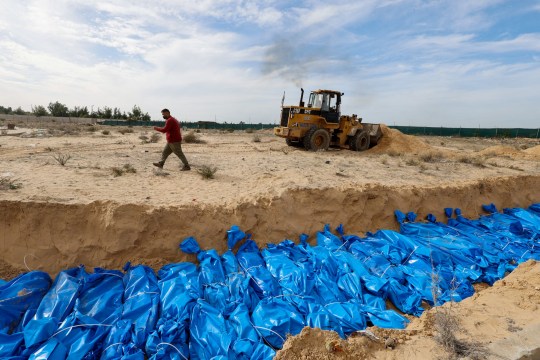 The bodies of Palestinians killed in Israeli strikes and fire are buried in a mass grave, after they were transported from Al Shifa hospital in Gaza City for burial, in Khan Younis in the southern Gaza Strip November 22, 2023. REUTERS/Mohammed Salem