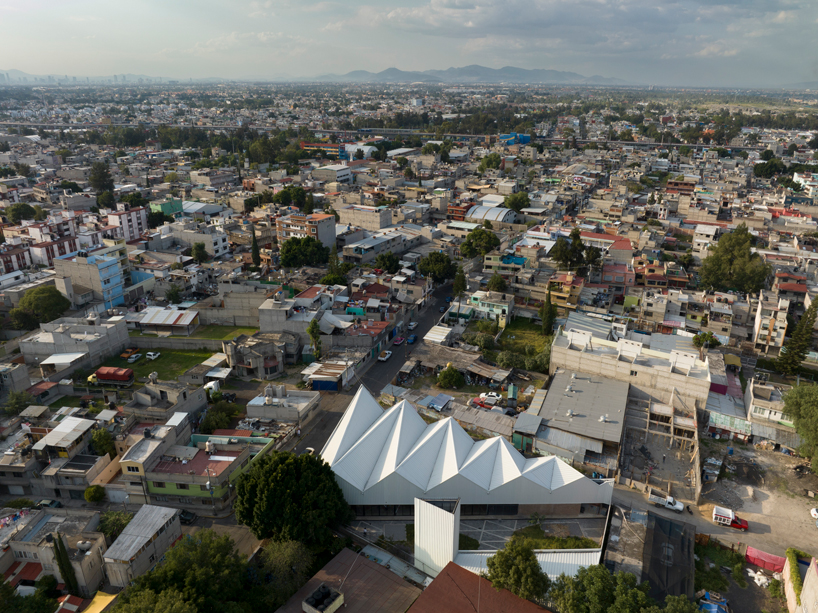 metallic roof shapes triangular folds atop a|911's cultural infrastructure in mexico city