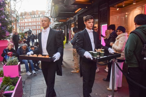 Pastries and hot drinks were served yesterday as customers queued outside Harrods in Knightsbridge for the Boxing Day sale.