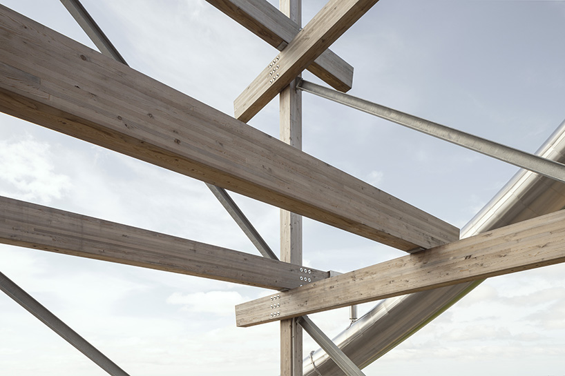 holzer kobler inserts large cubes within timber framework for communal space in germany