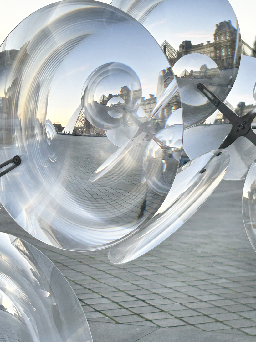 kinetic cloud's floating lenses by vincent leroy deform louvre's facade
