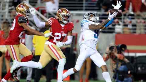 Detroit Lions wide receiver Jameson Williams, right, tries to catch a pass in front of San Francisco 49ers cornerback Ambry Thomas, left, and safety Ji’Ayir Brown, centre, during the NFC Championship game in Santa Clara, California, on Sunday