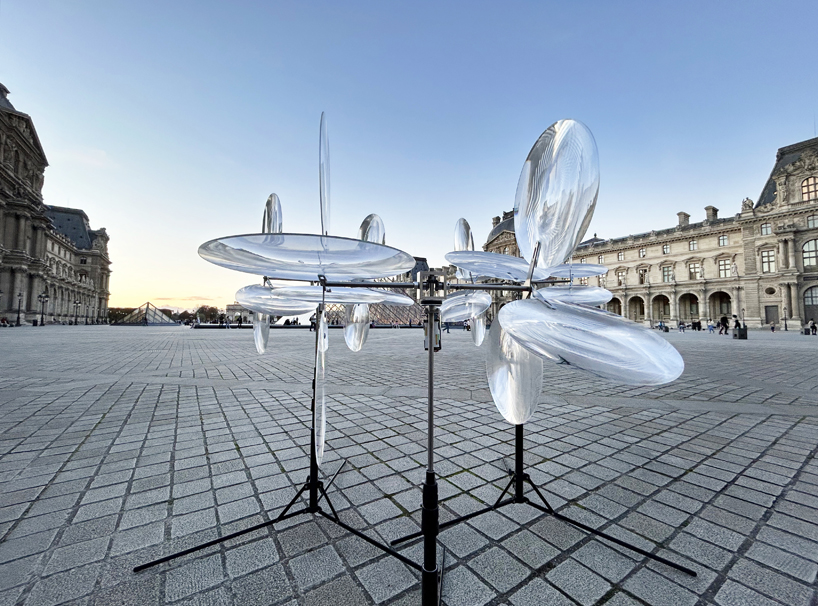 kinetic cloud's floating lenses by vincent leroy deform louvre's facade