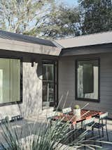 The clients opted for a standing seam metal roof, weatherboard cladding, and an L-shaped plan.