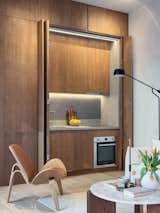 The kitchen, which has an induction cooktop and dishwasher, can also be concealed when not in use.&nbsp;