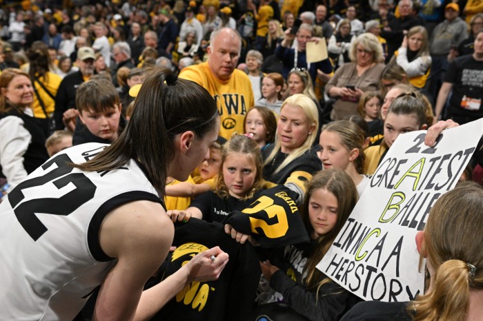 Caitlin Clark signing autographs for fans