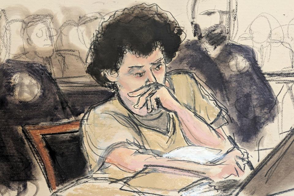 In this courtroom sketch, Sam Bankman-Fried, center, makes notes during his sentencing hearing in March 2024.