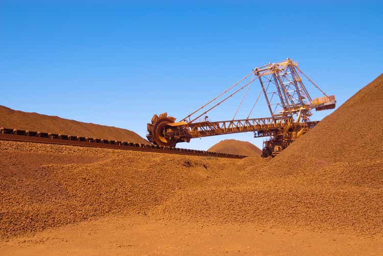 Reclaimer working on an iron ore site under blue sky