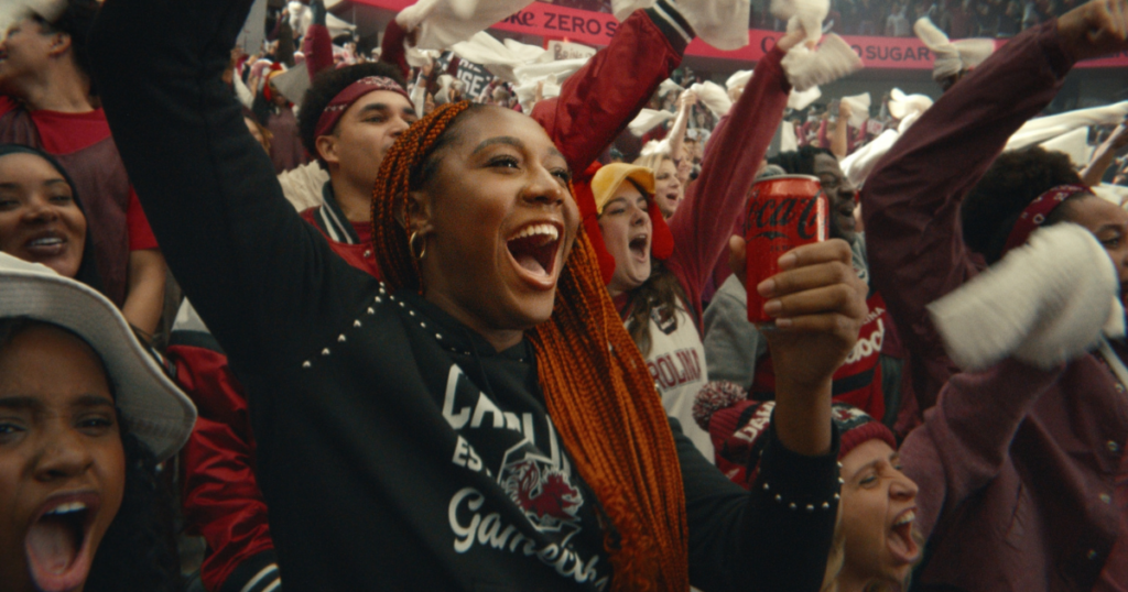 University of South Carolina alum Aliyah Boston cheering during a Coke Zero Sugar commercial