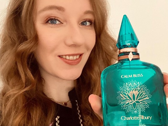 Courtney holding a bottle of Calm Bliss perfume