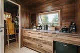 The kitchen cabinetry is made out of the same Thermowood that clads the home. The electric cooktop can be replaced with a gas one for off-grid use.
