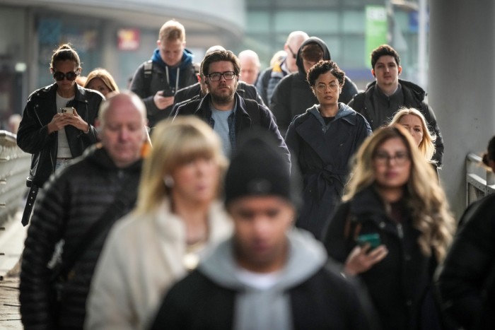 Commuters heading to work in Manchester, UK