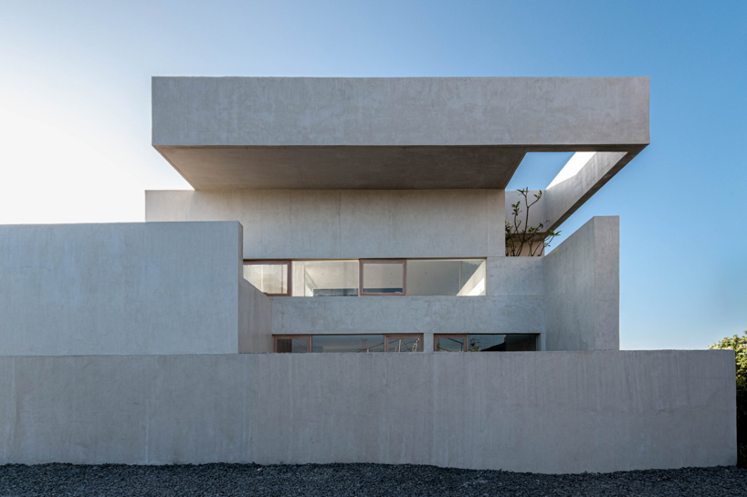 light and air permeate through residence's stacked concrete volumes in philippines