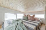 Douglas fir is used to both frame and line the floor of the loft. The millwork is left exposed in the bathroom beneath.