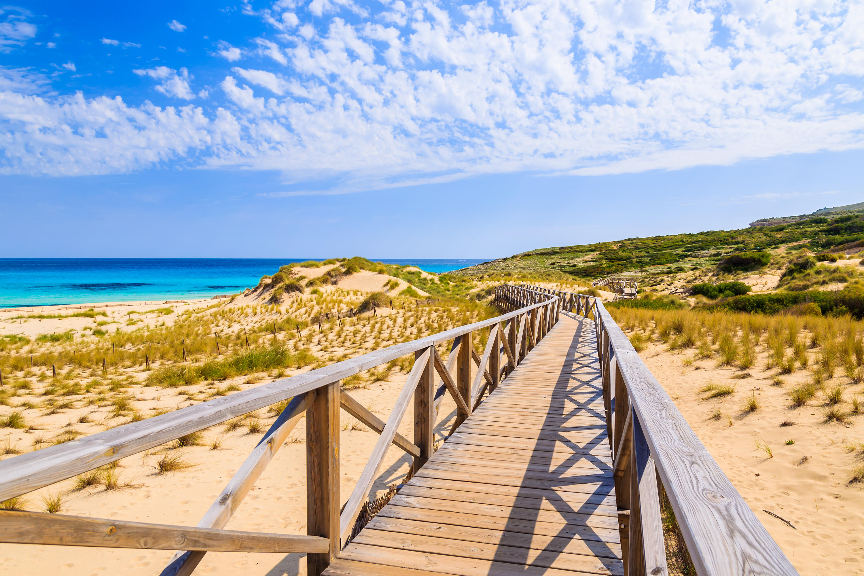 Wander the golden sand dunes to Cala Mesquida beach, Mallorca