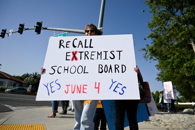 Protesters gather outside the Temecula Duck Pond on Wednesday, May 22, 2024, to call for the recall of Temecula school board President Joseph Komrosky. Supporters of the recall, which is winning in unofficial results, campaigned on the promise to 