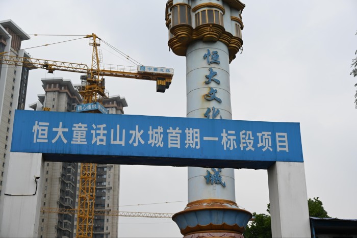 A Chinese building site with cranes and hoardings