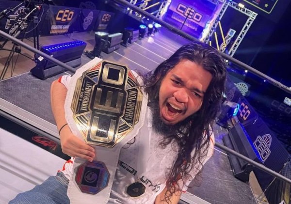 RezDyloch holding the CEO champion belt and appearing shocked standing in a wrestling ring