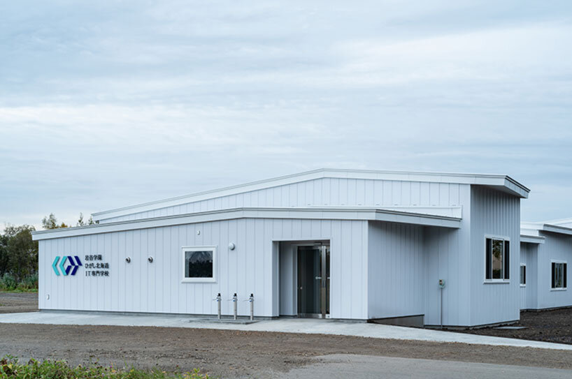 a series of small gabled homes forms atelier meme's specialized school in japan