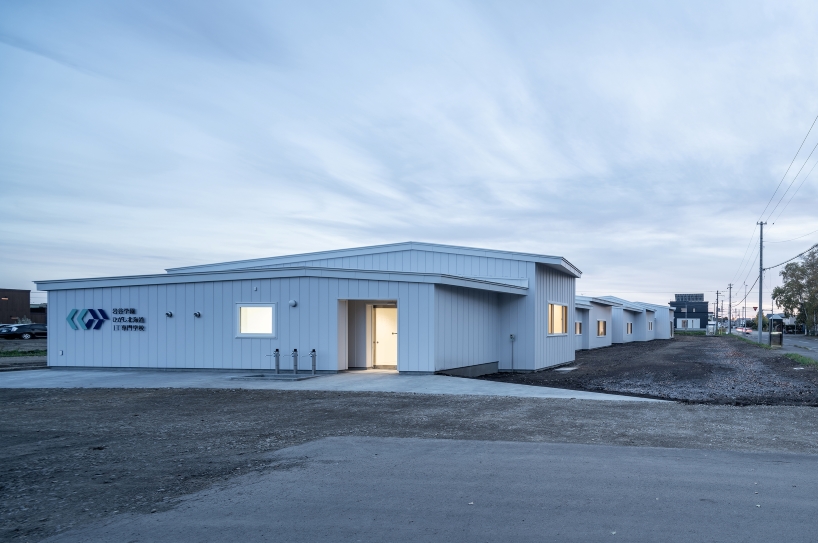 a series of small gabled homes forms atelier meme's specialized school in japan