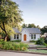 Once a derelict 1930s cottage, this renovated home in the heart of Austin conceals a metal-roofed addition that holds a glass-walled, cantilevered living space with a 28-foot concrete bench overlooking the rear garden, as well as a screened porch. The asymmetric gabled roof at the entry hints at the eccentric elements inside: there are wood details throughout, such as sinker cypress sills and ledges made from logs reclaimed in rivers and swamps. 