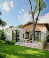 The architects and owners of this single-story Austin residence relocated the lot’s existing 1940s bungalow, where they’d lived for four years, to construct a new home that would complement the 400-square-foot rear studio they built two years prior. Natural light pours through the large skylight aligned with the central spine of the house. The home employs a mix of gable and flat roofs coupled with brick and vertical cedar siding.