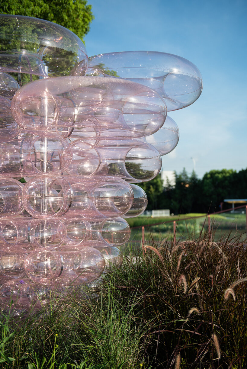 pink acrylic bubbles by naoonaoo compose undulating installation along suzhou's waterfront